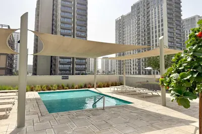a canopy over a swimming pool with buildings at PVH - Posh 2BR with 1 Queen Bed Plus 1 Single Bed - Collective 2-0 in Dubai
