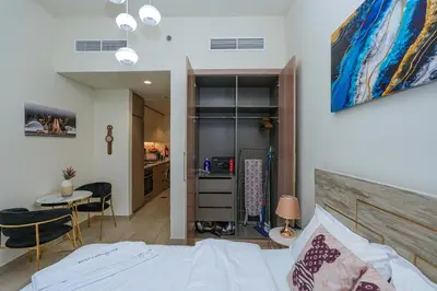 a bedroom with a bed and a desk and a table at The Riviera Nook Cozy Stay in Dubai in Dubai
