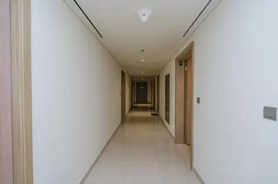 an empty corridor in a building with a hallway at The Riviera Nook Cozy Stay in Dubai in Dubai
