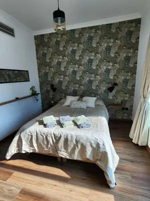 a bedroom with a large bed with a wall at Modern 1BR Apartment - Marina Walk in Dubai