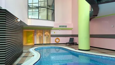 a swimming pool in the middle of a building at Modern 1BR Apartment - Marina Walk in Dubai