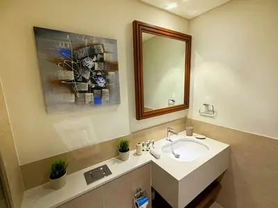 a bathroom with a sink and a mirror at Coastal Chic at Emaar Beachfront 1BR in Dubai