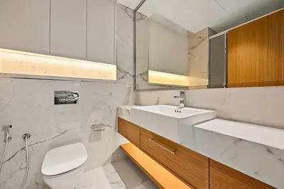 a bathroom with a white toilet and a sink at Estudio Coral en Dubai By BeBalmy in Dubai