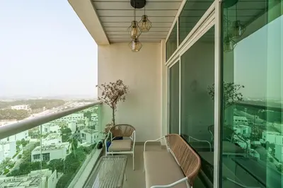 a balcony with chairs and a view of a city at Beachside Bliss With Stylish 2BR with Panoramic View in Dubai
