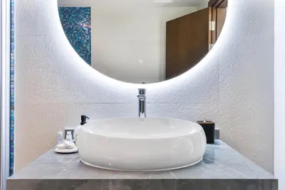 a sink in a bathroom with a large mirror at Beachside Bliss With Stylish 2BR with Panoramic View in Dubai