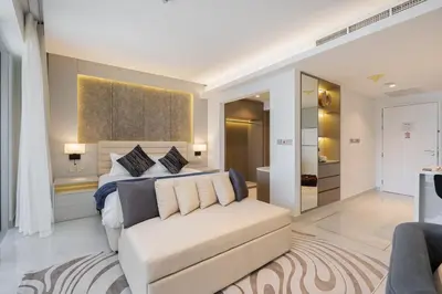 a bedroom with a bed and a couch at Vogue Downtown Emaar Residence Fashion Avenue with Direct Access to Dubai Mall, Studio Apartment with Balcony Overlooking Burj Khalifa View, Access to all Amenitties in Dubai