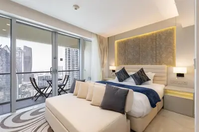 a bedroom with a king sized bed and a balcony at Vogue Downtown Emaar Residence Fashion Avenue with Direct Access to Dubai Mall, Studio Apartment with Balcony Overlooking Burj Khalifa View, Access to all Amenitties in Dubai
