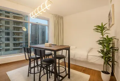 a room with a table and chairs and a bed at Luxury 2BR in Downtown w Iconic Burj Khalifa View Burj Views 303 in Dubai