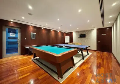 a billiard room with two tables in it at Spacious 1BR Apartment - The Jewels Tower 2 - Dubai Marina in Dubai