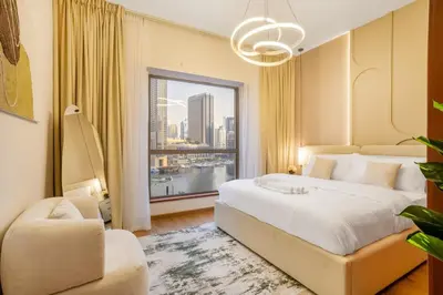 a bedroom with a large bed and a large window at Luxurious 3BHK w Marina Views & Pool Table by dPie Sadaf 408 in Dubai