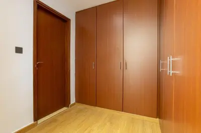 an empty room with wooden cabinets and a door at Luxurious 3BHK w Marina Views & Pool Table by dPie Sadaf 408 in Dubai