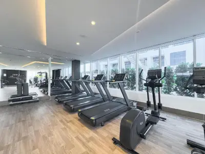 a gym with a row of treadmills and elliptical machines at Luxury 2 BR in Al Barsha Opalz Danube by dpie A312 in Dubai