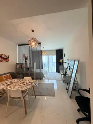 a dining room and living room with a table and chairs at Convenient studio in the centre of Dubai in Dubai