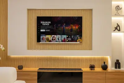 a living room with a picture on the wall at Luxury 4 BHK Villa in JVC by dPie in Dubai