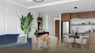a living room with a blue couch and a kitchen at Ultra Luxury Emaar Palace Beachfront 1BR Five Palm in Dubai