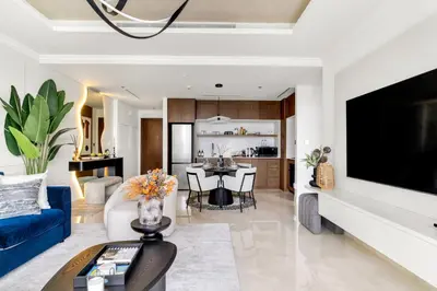 a living room with a blue couch and a tv at Ultra Luxury Emaar Palace Beachfront 1BR Five Palm in Dubai