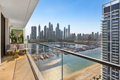 a balcony with a view of a city at Ultra Luxury Emaar Palace Beachfront 1BR Five Palm in Dubai