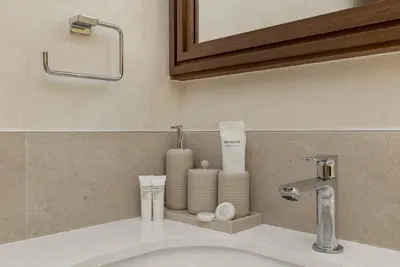 a bathroom sink with toiletries on a counter at Ultra Luxury Emaar Palace Beachfront 1BR Five Palm in Dubai