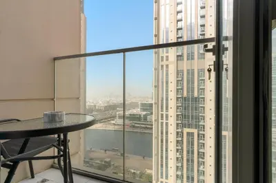 a table in a room with a view of a building at ALiving Luxury 1BR Apartment with City View I Amna Tower, Al Habtoor City in Dubai