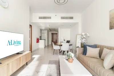 a living room with a couch and a tv at ALiving Luxury 1BR Apartment with City View I Amna Tower, Al Habtoor City in Dubai
