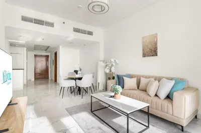 a living room with a couch and a table at ALiving Luxury 1BR Apartment with City View I Amna Tower, Al Habtoor City in Dubai