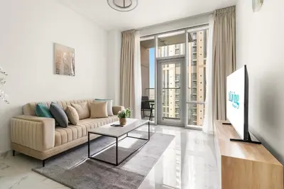 a living room with a couch and a table at ALiving Luxury 1BR Apartment with City View I Amna Tower, Al Habtoor City in Dubai