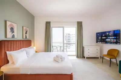 a hotel room with a bed and a window at Premium Ensuite Room With Balcony in Dubai