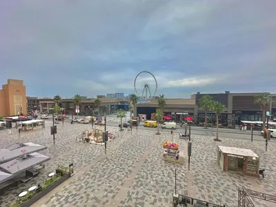an empty plaza with a ferris wheel in the background at Premium Ensuite Room With Balcony in Dubai