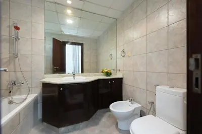 a bathroom with a toilet and a sink and a tub at Premium Ensuite Room With Balcony in Dubai