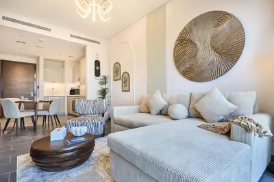 a living room with a couch and a table at STAY BY LATINEM Luxury 1BR Holiday Home CA 0305 Near Burj Khalifa in Dubai