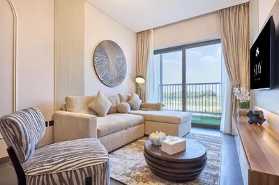 a living room with a couch and a table at STAY BY LATINEM Luxury 1BR Holiday Home CA 0305 Near Burj Khalifa in Dubai