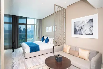 a hotel room with a bed and a couch at Canal Bliss Studio- DAMAC Maison Prive in Dubai