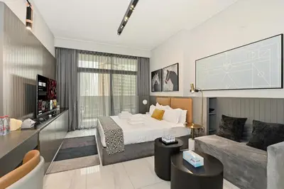 a hotel room with a bed and a couch at Downtown Dubai, Canal view ,Mag318 in Dubai