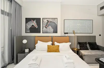 a bedroom with a large bed and a couch at Downtown Dubai, Canal view ,Mag318 in Dubai