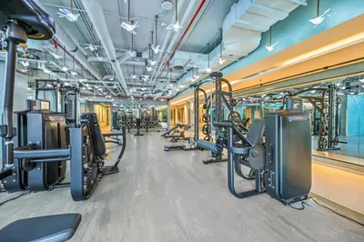a gym with rows of treadmills and machines at Downtown Dubai, Canal view ,Mag318 in Dubai