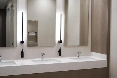 a bathroom with three sinks and two mirrors at BRAND NEW FULL MARINA VIEW 1BR Apartment at LIV Marina in Dubai