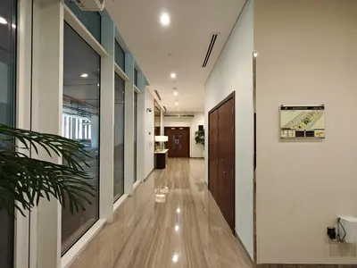 a hallway of an office with a door and a plant at Centrally Located 1 BR in Damac Reva - 7 Min walk to Dubai Mall in Dubai