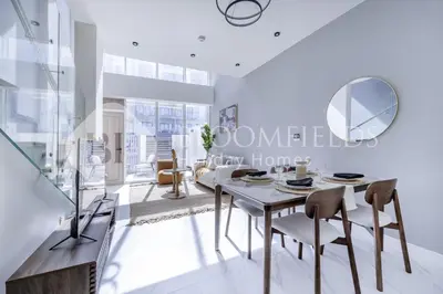a dining room with a table and chairs at Bloomfields Deluxe 1br Rukan in Dubai