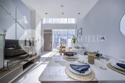 a dining room with a table with hats and wine glasses at Bloomfields Deluxe 1br Rukan in Dubai