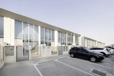 a car parked in a parking lot next to a building at Bloomfields Deluxe 1br Rukan in Dubai