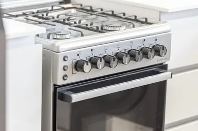 a stove top oven in a kitchen at 1BR Luxury Stay With Pool, Gym and Skyline View in Dubai