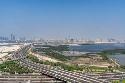 an aerial view of a highway with a city at Elegant 2-Bedroom Apartment with Stunning City and Water Views in Dubai