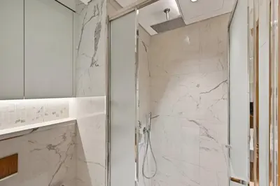a bathroom with a shower with white marble at Estudio Noor en Dubai Por beBalmy in Dubai