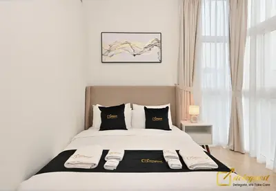 a bedroom with a large white bed with black pillows at Luxurious 3BR Villa Getaway in DH2 by Deleguest in Dubai