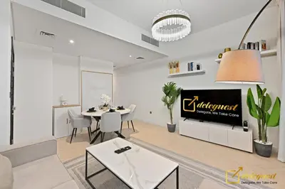 a living room with a table and a tv at Luxurious 3BR Villa Getaway in DH2 by Deleguest in Dubai