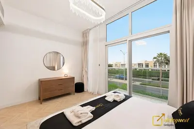 a bedroom with a bed and a large window at Luxurious 3BR Villa Getaway in DH2 by Deleguest in Dubai