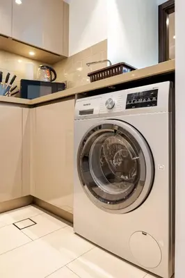 a white washer and dryer in a kitchen at Stunning I Biggest Studio I Near To Downtown in Dubai