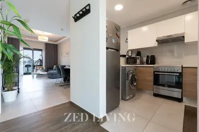a kitchen and living room in a apartment at Sol Bay - Stay in style with Burj Khalifa views - Zed Living in Dubai