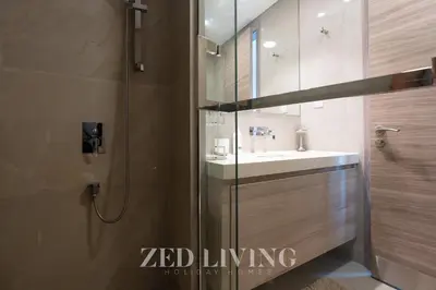 a bathroom with a sink and a glass shower at Sol Bay - Stay in style with Burj Khalifa views - Zed Living in Dubai