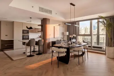 a kitchen and dining room with a table and chairs at Luxury 4 Bedroom Penthouse in Dubai Marina in Dubai